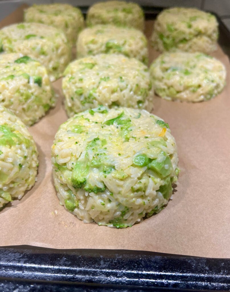 Broccoli cheddar rice portioned out on a sheet pan.